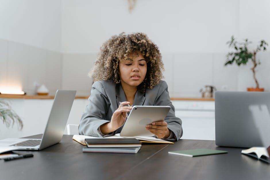 Tradesperson working through business training materials on a tablet